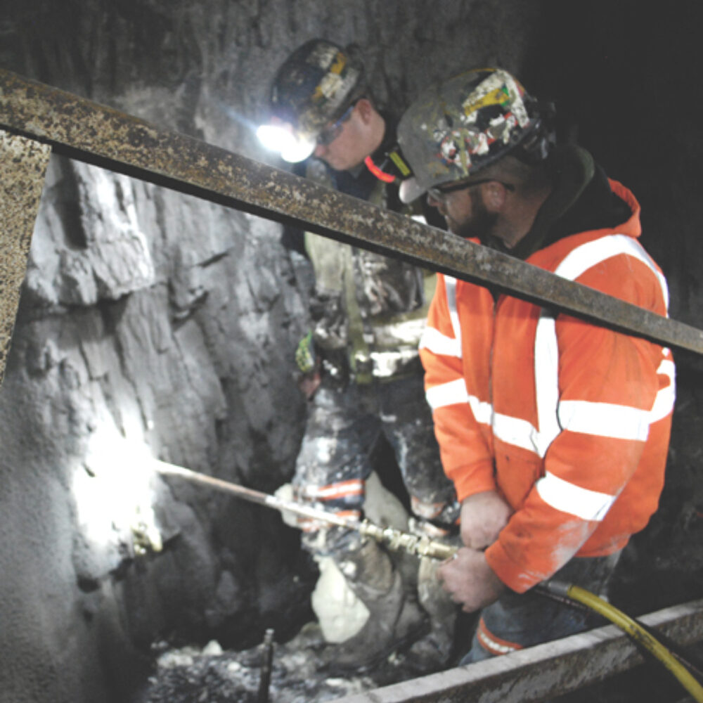 Men mining underground using geotech