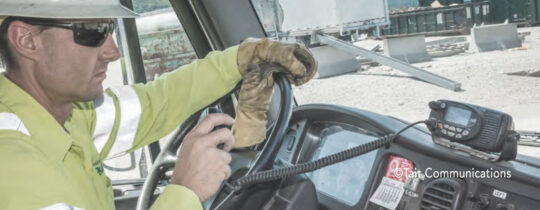 Man in mining gear driving a truck