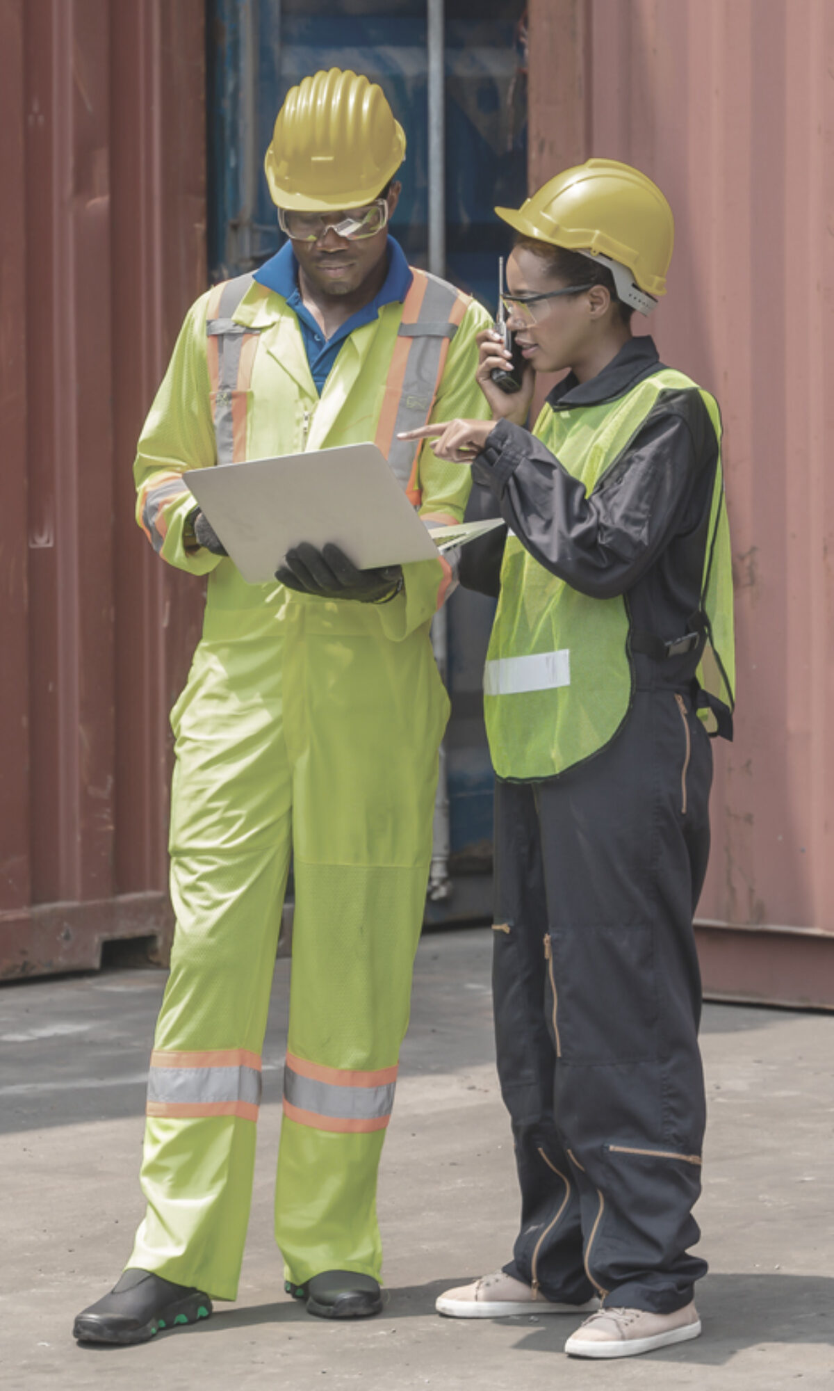 Man and woman in hardhats looking at document